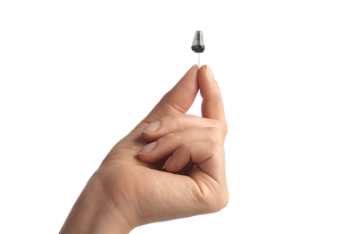 A tiny invisible-in-canal hearing aid held between finger and thumb