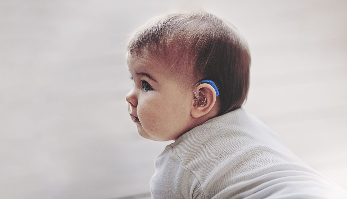 A baby wearing a hearing aid